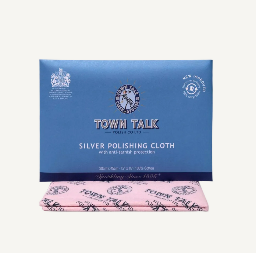 A blue rectangular box of Town Talk Silver Polishing Cloth with a folded pink cloth underneath, photographed on a plain white background.